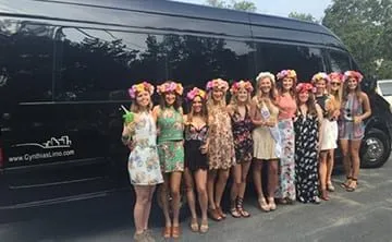 Bachelorette party in front of a Cynthia's Limo Sprinter van