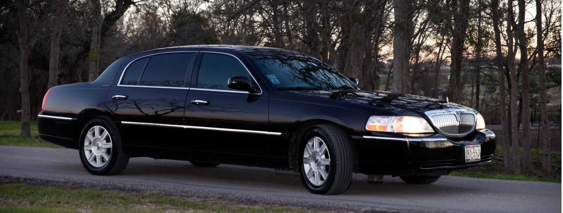 Black Lincoln Town Car L-Series at dusk — Cynthia's Manhattan Limousine, Austin's premier limo service