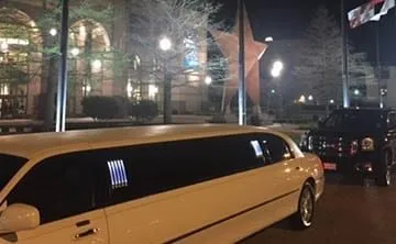 Stretch limousine arriving at a special event in Austin at night